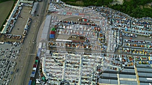 Top aerial view of many cars on a parking lot of department stores. 4K.