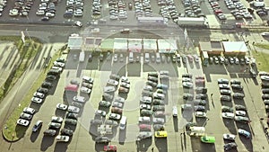 Top aerial view of many cars on a parking lot or sale car dealer market.