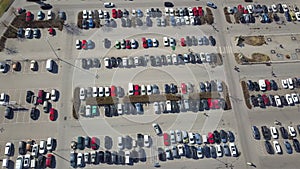 Top aerial view of many cars on a parking lot or sale car dealer market.