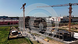 Top aerial view of a massive construction site with a house in a city