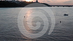 Top Aerial view moving fishing boat ocean. evening sailing motor boat with angler on Dnipro river at sunrise sunset