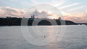 Top Aerial view moving fishing boat ocean. evening sailing motor boat with angler on Dnipro river at sunrise sunset