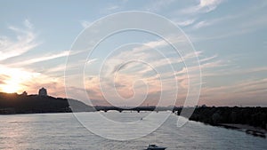 Top Aerial view moving fishing boat ocean. evening sailing motor boat with angler on Dnipro river at sunrise sunset