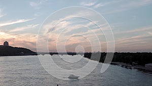 Top Aerial view moving fishing boat ocean. evening sailing motor boat with angler on Dnipro river at sunrise sunset