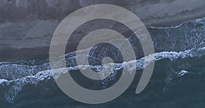 Top aerial view of ocean waves. Empty beach in South of France