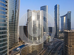 Top aerial view shot of city skyscrapers from a modern office space | Al Reem island Sun and Sky towers and landmarks in Abu Dhabi