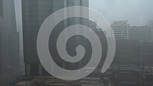 Top aerial view shot of skyscrapers in the city Rain and thunder storm in Abu Dhabi city, UAE skyline and downtown