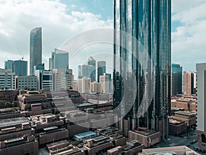 Top aerial view shot of skyscrapers in a modern city with fog clouds passing by - Downtown Abu Dhabi landmarks and World Trade Cen