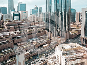 Top aerial view shot of skyscrapers in a modern city with fog clouds passing by - Downtown Abu Dhabi landmarks and World Trade Cen