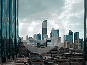 Top aerial view shot of skyscrapers in a modern city with fog clouds passing by - Downtown Abu Dhabi landmarks and World Trade Cen