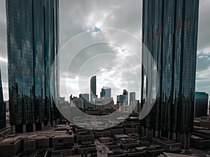 Top aerial view shot of skyscrapers in a modern city with fog clouds passing by - Downtown Abu Dhabi landmarks and World Trade Cen