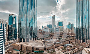 Top aerial view shot of skyscrapers in a modern city with fog clouds passing by - Downtown Abu Dhabi landmarks and World Trade Cen