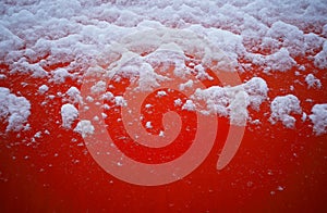 Top aligned snow on red steel surface texture background