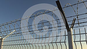 Top of barbed wire fence against sky, 3D rendering