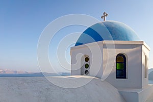 The top of a beautiful church with blue round roof in santorini, greece