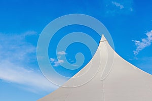 The top of big canvas event tent under the beautiful clear blue