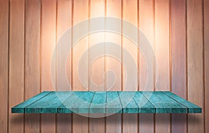 Top of blue wooden shelf with spot light on wooden wall background