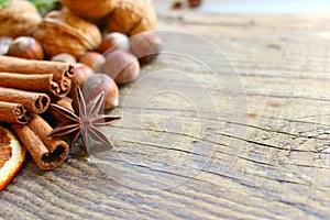 Top border of festive spices and baking ingredients on rustic wooden background. Christmas, New year background