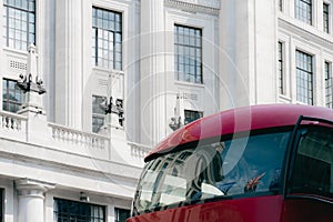 Top of British Red Double Decker Bus with reflection of Union Jack flag in London, UK