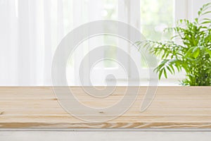 Top of brown wood table on blurred curtained window background