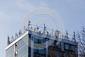 Top of building full of satellites and microwaves connections - Stay tuned