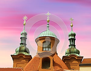 Top of Cathedral of St Lawrence against pink sky, Prague