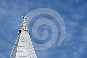 Top of christian church on the cloudy blue sky