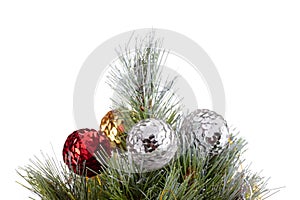 Top of Christmas tree. Green pine branches decorated with golden, silver, and red balls. Silver, golden, red balls are out of