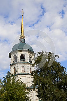 The top of the Church with a green dome view through the trees.Bottom view.