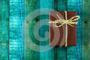 Top close up shot of a brown gift box with green and blue background. New year 2020 gifts