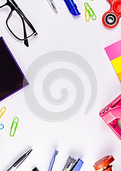 Top close up shot of stationary items on a white background in literacy and education concept