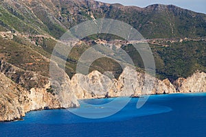 Top close up view at Assos peninsula cliffs and blue Ionian Sea water. Aerial view, summer scenery of famous travel