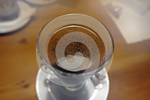 Top close-up view on glass cup with hot cowboy coffee drink