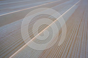 Top close up view of stack of three-layer wooden glued laminated timber beams from pine finger joint spliced boards