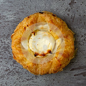 Top close view of a delicious cream cheese danish on a gray mottled tabletop