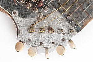 Top closeup horizontal studio shot of vintage, old wooden zither isolated on white background. Detail of zither