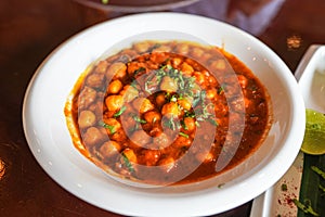 Top closeup view of chole masala or chana an indian street food made of chickpeas, tomatoes and cumin