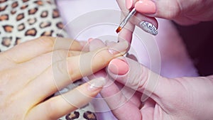 Top coating of clear nail Polish.Preparation of a nail for painting by a new varnish. Covering top. A transparent top on