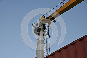 Top of column jib crane of the merchant cargo container vessel.