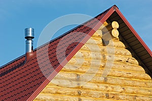 Top of country wooden house with red roof