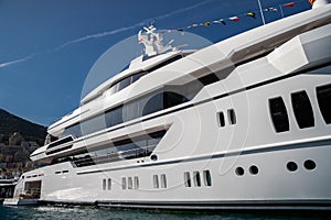 The top deck of a huge yacht at sunny day, glossy board of the boat, The chrome plated handrail, megayacht is moored in