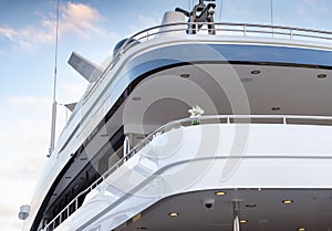 The top deck of a huge yacht at sunset, Glossy board of the boat, The chromeplated handrail, pink sky