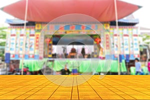 Top desk with blur chinese opera stage background,wooden table