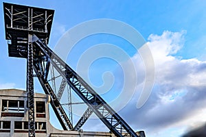 Top of disused shaft tower of former Waterschei coal mine against blue sky