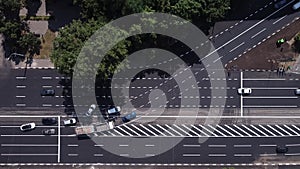 Top down aerial of cars drive at crossroad. City traffic on intersection.