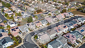 Top Down aerial photos over a community in California with homes with solar panels and roadways and parks