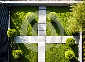 Top down aerial view of an austere minimalist garden with a crisscrossed light flagstone path on a trimmed lawn, made with