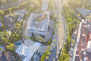 Top down aerial view of Beverly Hills neighborhood, Beverly Hills Hotel, and Sunset Boulevard surrounded with palm trees