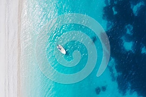 top down aerial view of boat at Fteri Beach on the Greek island of Kefalonia, Ionian Sea Greece. Turquoise colored water