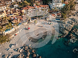 Top down aerial view of Conchas Chinas Beach in Puerto Vallarta Mexico showing rocks, sand, beauty